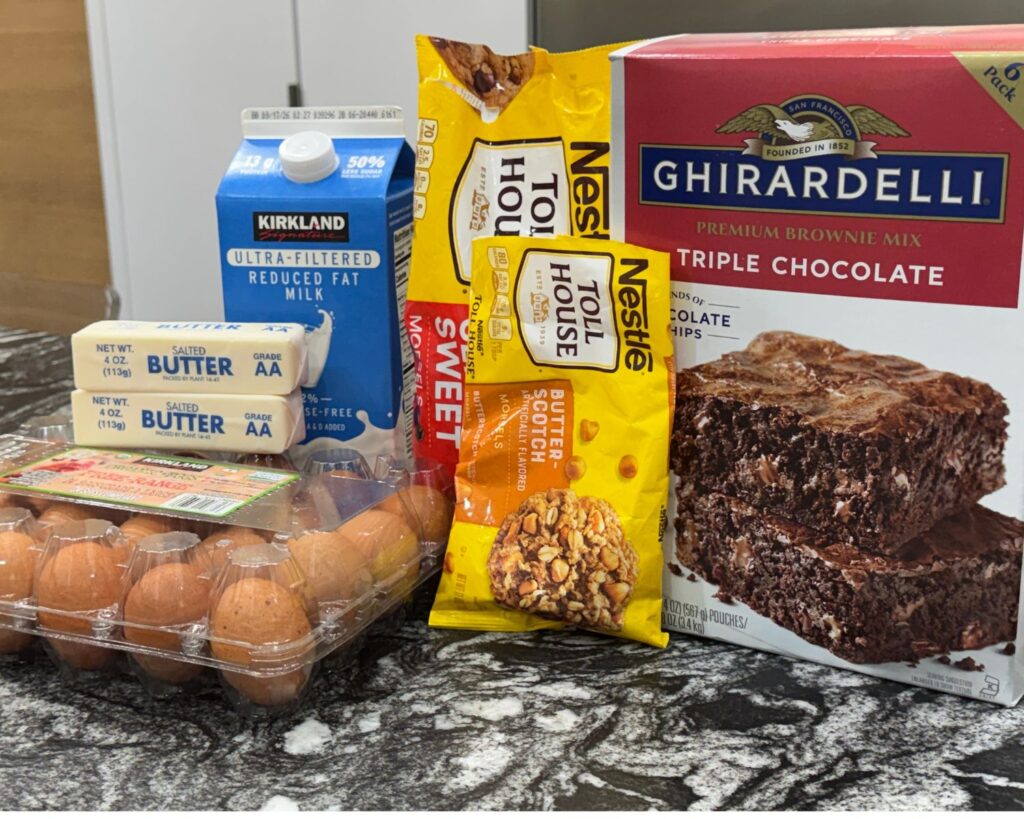 Ingredients for an easy brownie recipe including brownie mix, butter, milk, eggs, and chocolate chips.