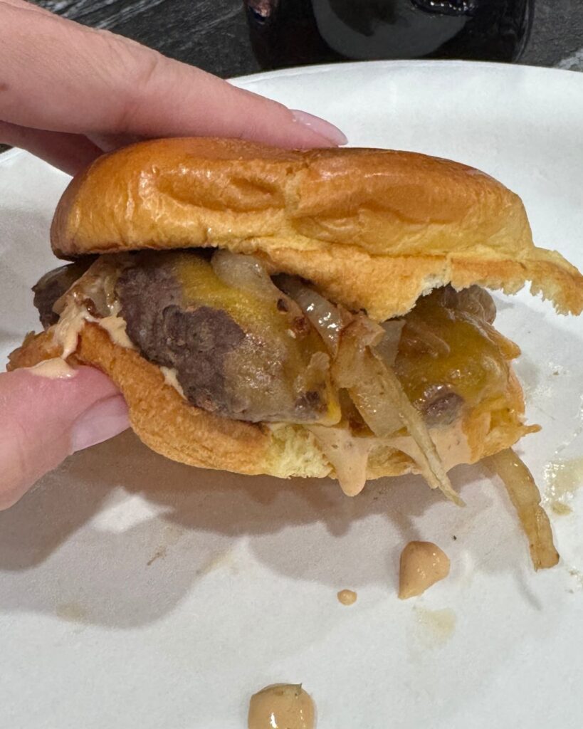 Double smash burger with melted cheese and grilled onions on a toasted brioche bun