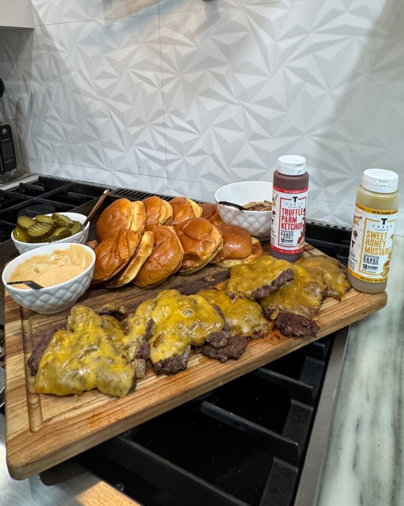 Homemade smash burgers with melted cheese, grilled onions, toasted brioche buns and burger seasonings