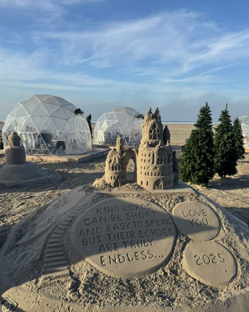 Sandcastle on the beach near Hotel Del Coronado with holiday igloos in the background