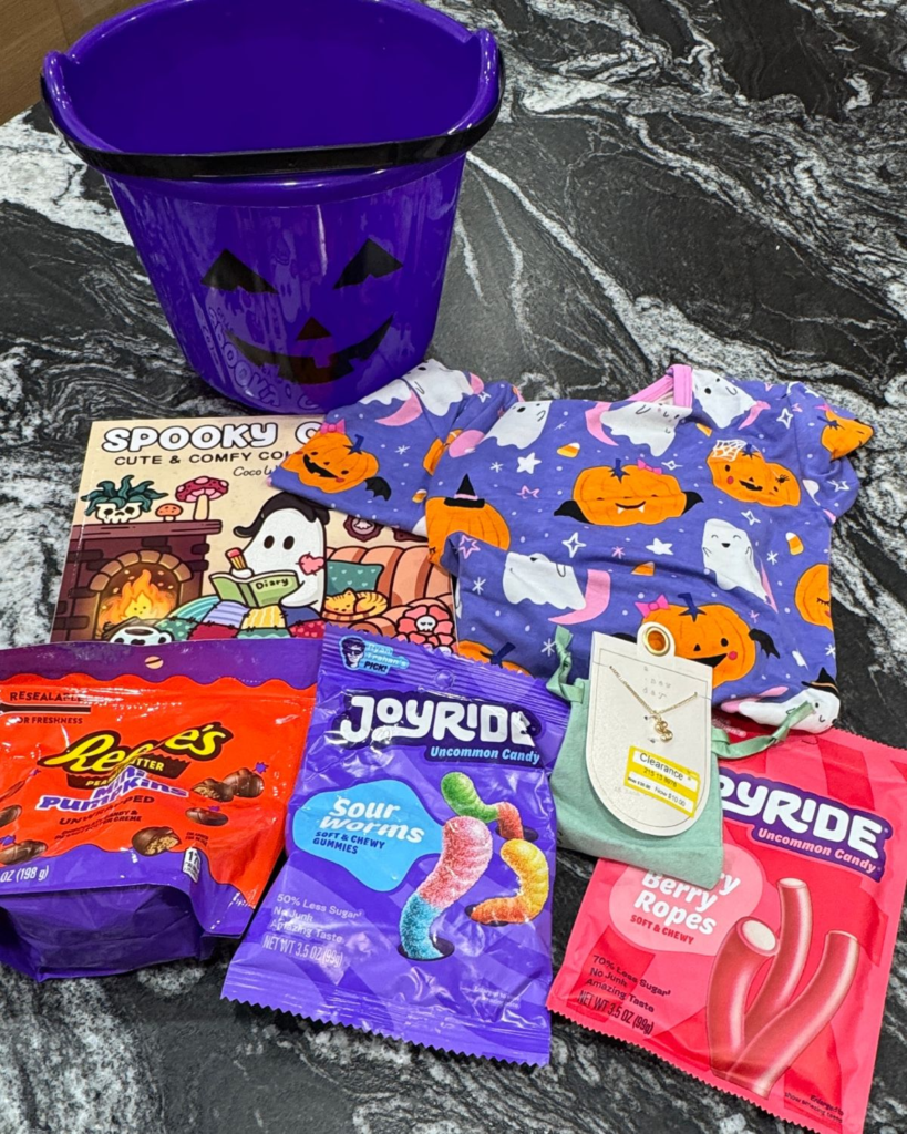 Halloween boo basket items for a 9-year-old, including candy, small gifts, and a purple bucket