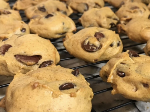 Homemade pumpkin chocolate chip cookies cooling on wire racks after baking