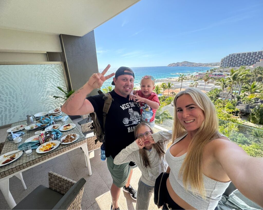 Family sitting together on a patio at Garza Blanca Cabo