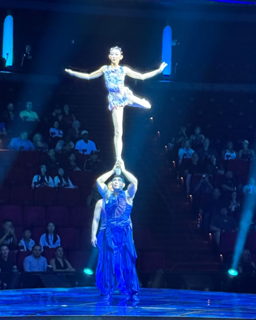 Awakening performer balancing above another performer on stage at Wynn Las Vegas