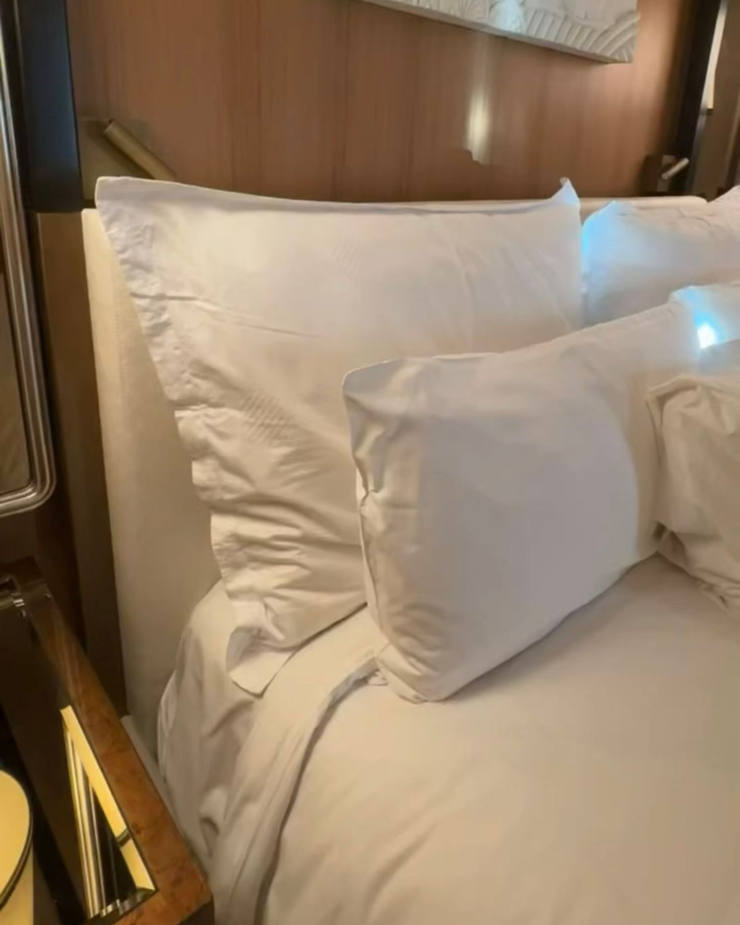 King bed with white linens inside a Wynn Las Vegas hotel room