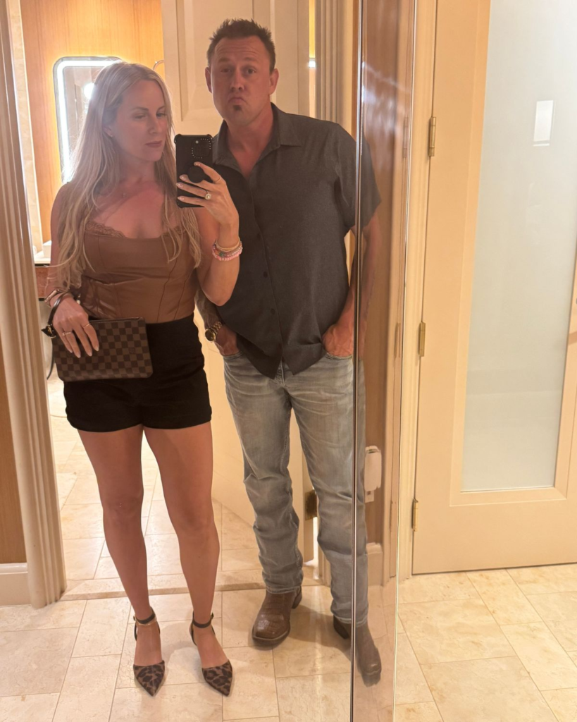 Julie and Corey taking a mirror selfie in their Wynn Las Vegas hotel room before dinner
