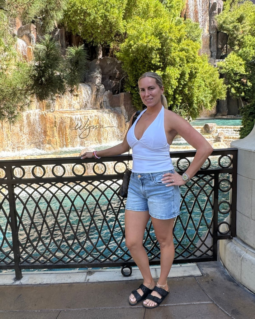 Julie standing in front of the waterfall at Wynn Las Vegas